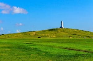 a panorama of the Wright Brothers National Monument on top of a tall hill