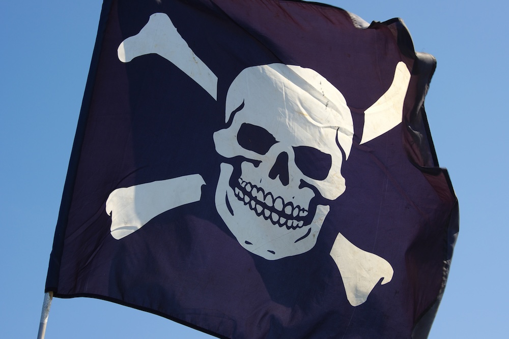 Jolly Roger flag on a blue sky background