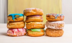 Stack of donuts on light wooden background