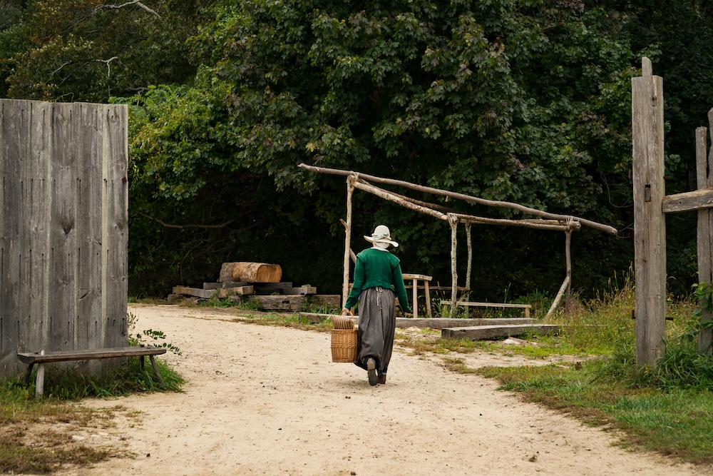 Colonial American Woman walking in a field doing chores