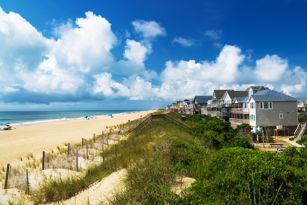 Sand dunes and Rows of beach houses on stilts on the outer banks.