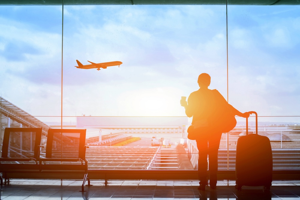 happy traveler waiting for the flight in airport, departure terminal, immigration concept