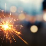 Burning sparkler with bokeh light background